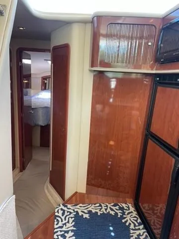  Yacht Photos Pics Interior of 2003 Sea Ray 400 Sedan Bridge, featuring wood paneling and modern design.