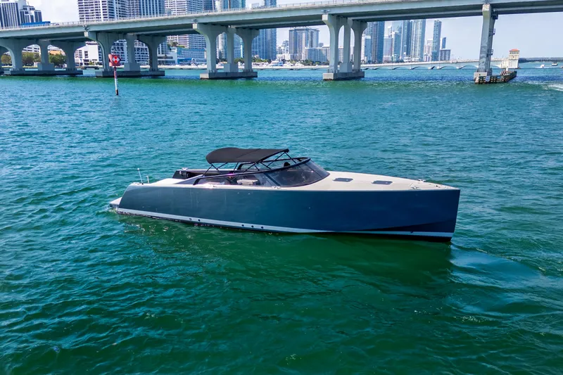 Drakaris Yacht Photos Pics 2014 VanDutch 40 yacht cruising on blue waters near a city bridge.