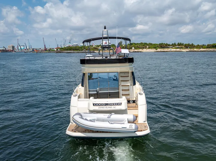 Good Deeds Yacht Photos Pics 2015 Beneteau Monte Carlo 5 yacht on water, rear view with inflatable boat.