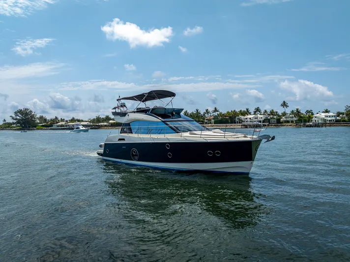 Good Deeds Yacht Photos Pics 2015 Beneteau Monte Carlo 5 yacht cruising on a sunny day near a coastal area.
