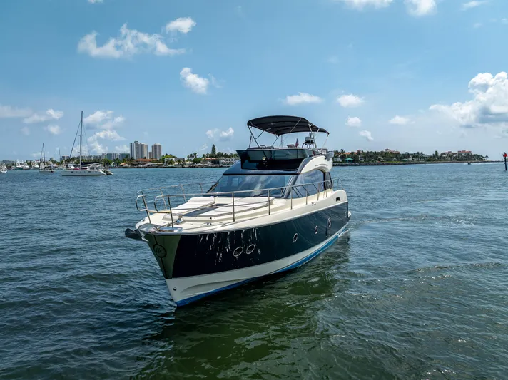 Good Deeds Yacht Photos Pics 2015 Beneteau Monte Carlo 5 yacht cruising on a sunny day in open waters.