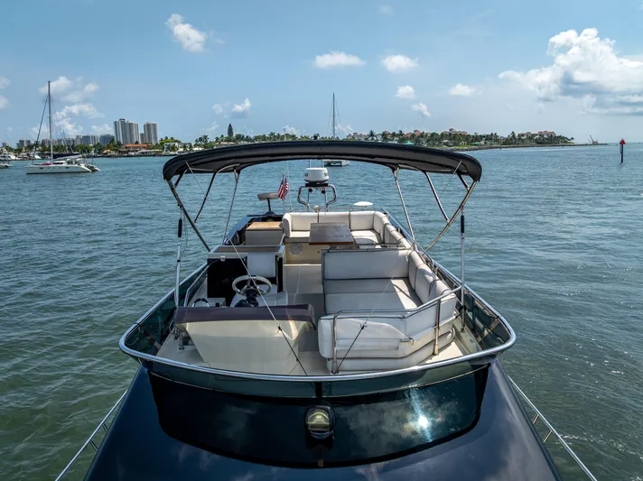 Good Deeds Yacht Photos Pics 2015 Beneteau Monte Carlo 5 yacht on water, featuring spacious deck and canopy.