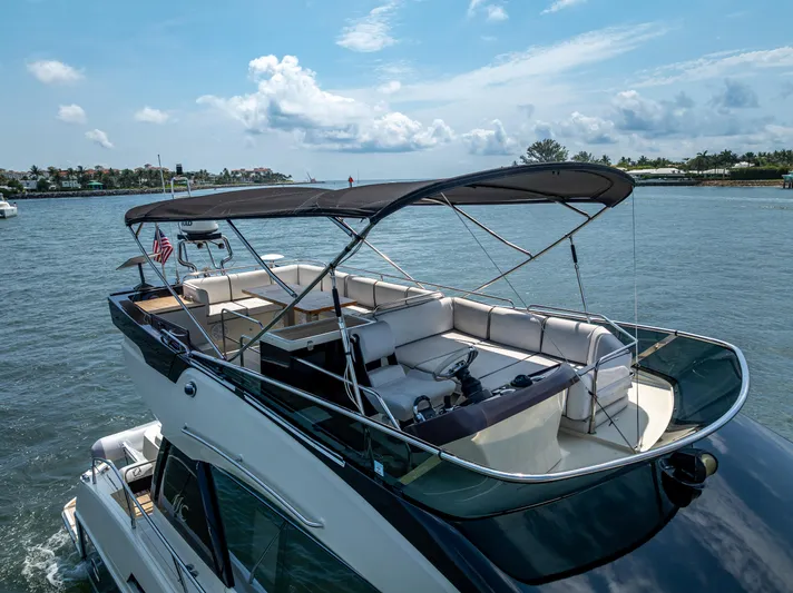 Good Deeds Yacht Photos Pics 2015 Beneteau Monte Carlo 5 yacht with spacious deck, cruising on a sunny day.