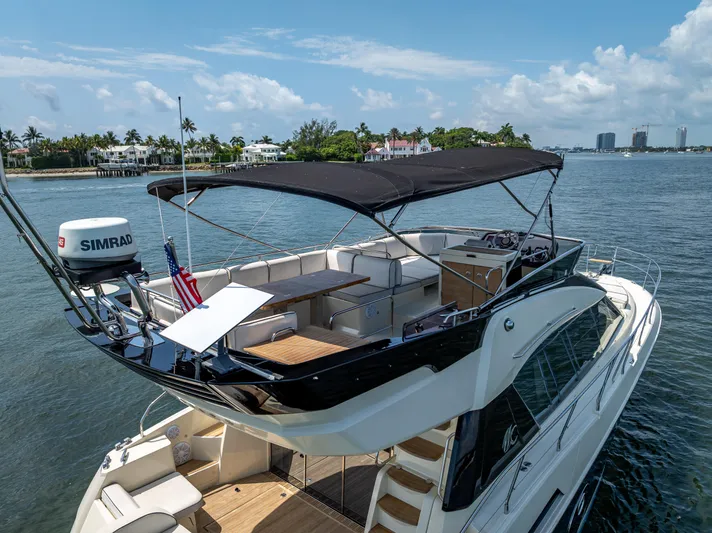 Good Deeds Yacht Photos Pics 2015 Beneteau Monte Carlo 5 yacht with flybridge, cruising on a sunny day.