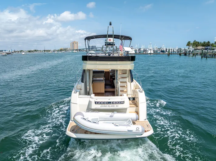 Good Deeds Yacht Photos Pics 2015 Beneteau Monte Carlo 5 yacht cruising in a marina, rear view.