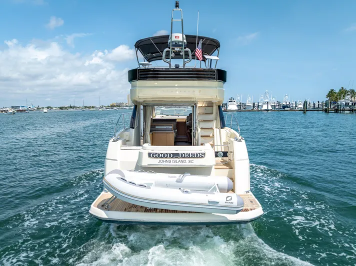 Good Deeds Yacht Photos Pics 2015 Beneteau Monte Carlo 5 yacht cruising on open water, rear view.
