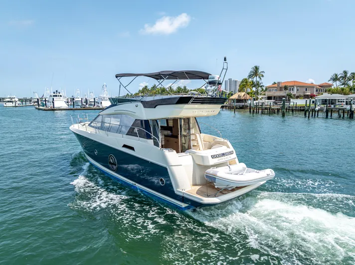 Good Deeds Yacht Photos Pics 2015 Beneteau Monte Carlo 5 yacht cruising in a sunny marina.