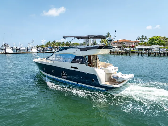 Good Deeds Yacht Photos Pics 2015 Beneteau Monte Carlo 5 yacht cruising in a sunny marina.