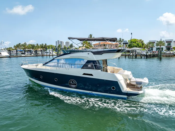 Good Deeds Yacht Photos Pics 2015 Beneteau Monte Carlo 5 yacht cruising in a sunny marina.