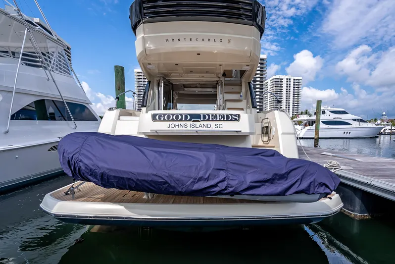 Good Deeds Yacht Photos Pics 2015 Beneteau Monte Carlo 5 yacht docked, rear view with covered equipment.