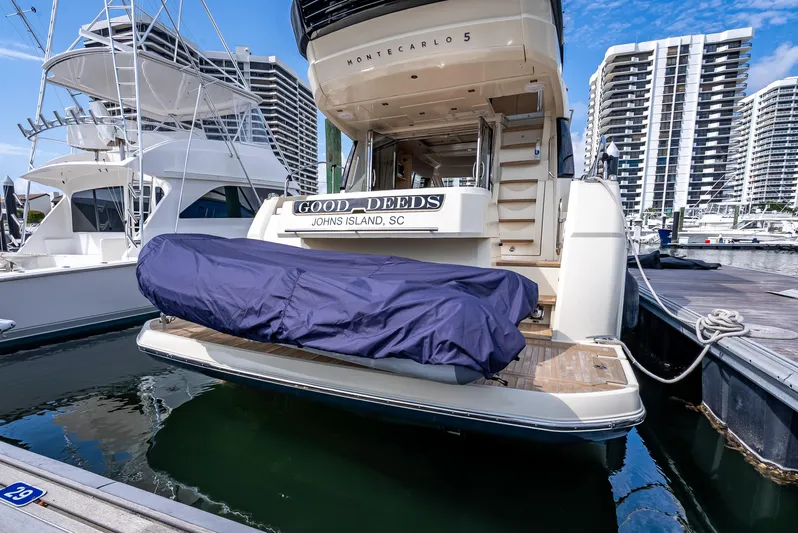 Good Deeds Yacht Photos Pics 2015 Beneteau Monte Carlo 5 yacht docked at marina with covered equipment.