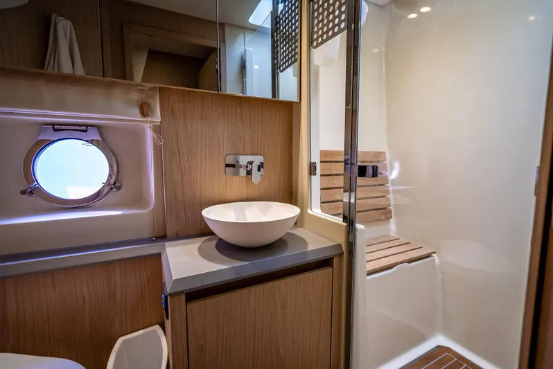 Good Deeds Yacht Photos Pics Luxurious bathroom in 2015 Beneteau Monte Carlo 5 yacht with modern fixtures and wooden accents.