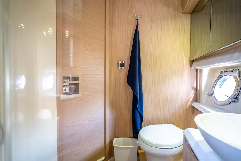 Good Deeds Yacht Photos Pics Luxurious bathroom in 2015 Beneteau Monte Carlo 5 yacht with modern fixtures and porthole window.