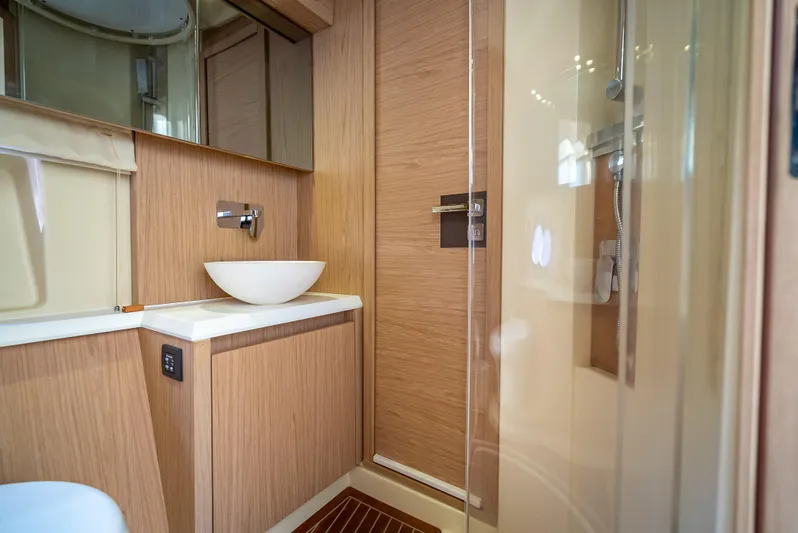 Good Deeds Yacht Photos Pics Luxurious bathroom in 2015 Beneteau Monte Carlo 5 yacht with modern fixtures and wood accents.