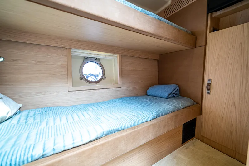 Good Deeds Yacht Photos Pics 2015 Beneteau Monte Carlo 5 cabin with bunk beds and porthole window.