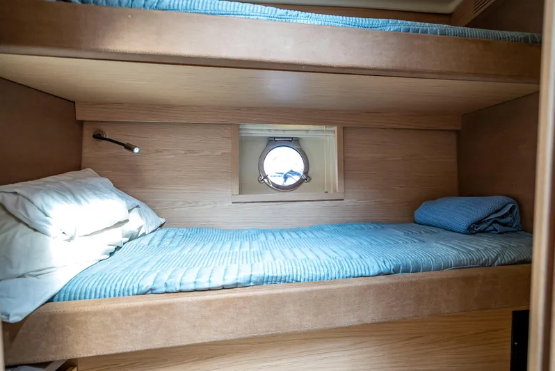 Good Deeds Yacht Photos Pics Bunk beds in 2015 Beneteau Monte Carlo 5 yacht cabin with porthole view.
