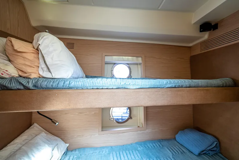 Good Deeds Yacht Photos Pics Bunk beds in 2015 Beneteau Monte Carlo 5 yacht cabin with porthole window.