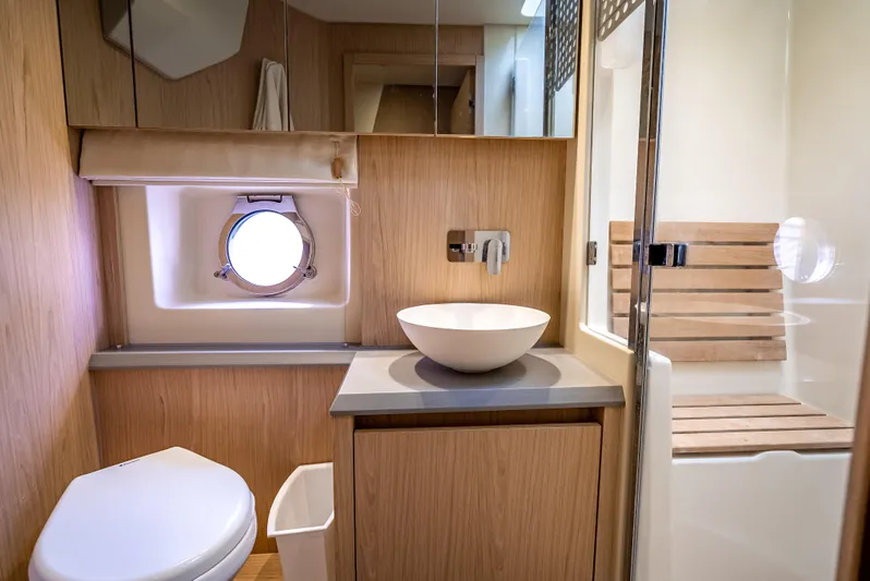 Good Deeds Yacht Photos Pics Luxurious bathroom interior of 2015 Beneteau Monte Carlo 5 yacht, featuring modern fixtures and wood accents.