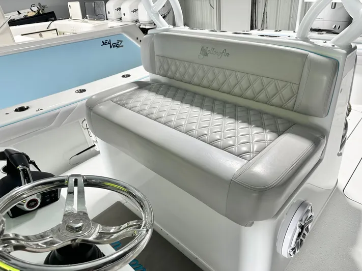  Yacht Photos Pics 2021 Yellowfin 36 Offshore boat interior with quilted seating and steering wheel.