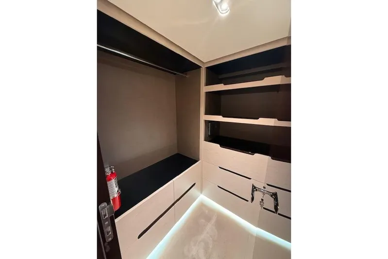  Yacht Photos Pics Luxurious interior closet of 2022 Azimut GRANDE 25 METRI yacht with modern shelving.