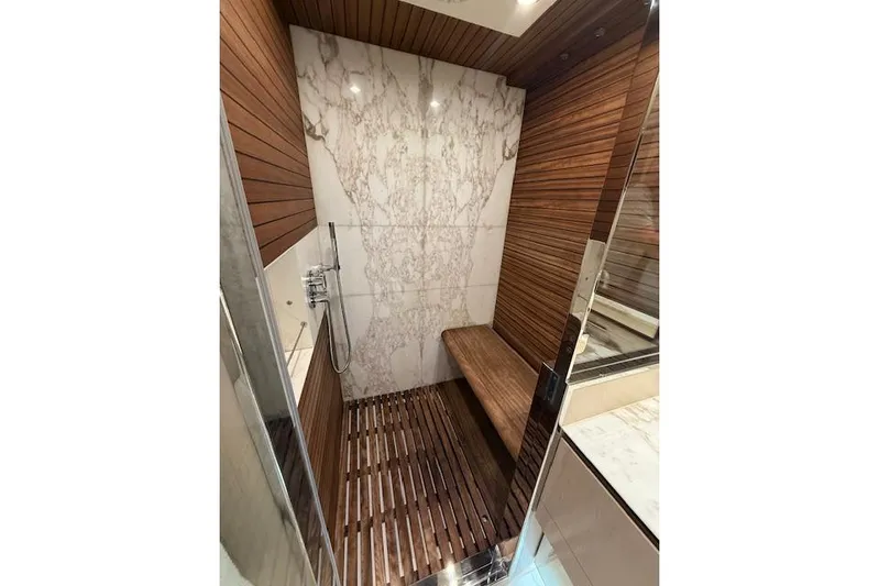  Yacht Photos Pics Luxurious shower in 2022 Azimut GRANDE 25 METRI yacht with wood and marble design.