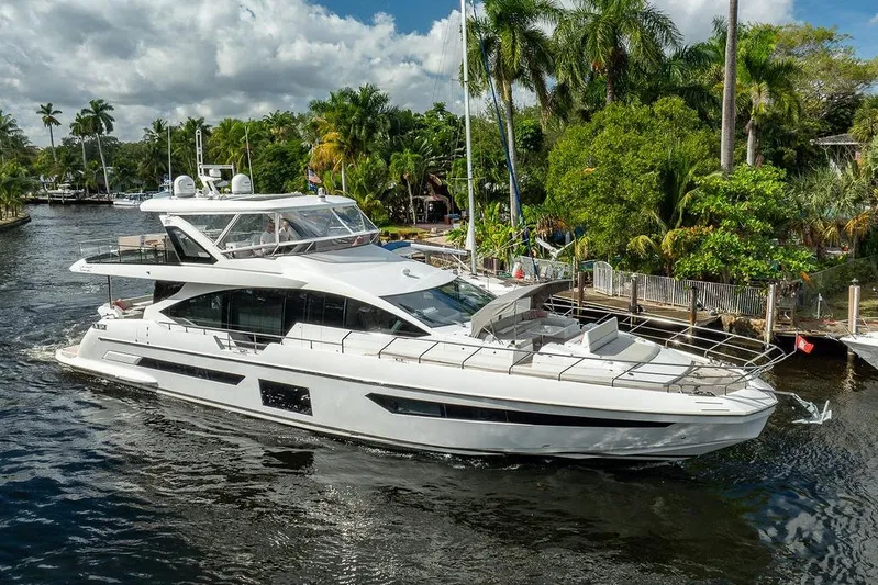  Yacht Photos Pics Luxury Azimut GRANDE 25 METRI yacht cruising on a scenic waterway, surrounded by lush greenery.