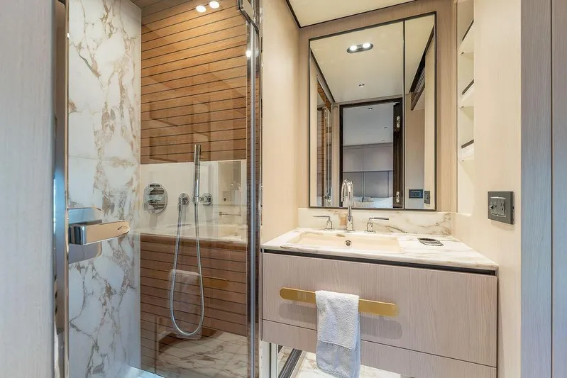  Yacht Photos Pics Luxurious bathroom in 2022 Azimut GRANDE 25 METRI yacht, featuring marble and wood accents.