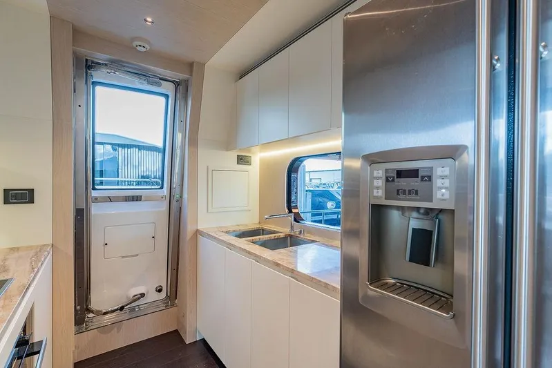  Yacht Photos Pics Modern kitchen interior of 2022 Azimut GRANDE 25 METRI yacht with stainless steel appliances.