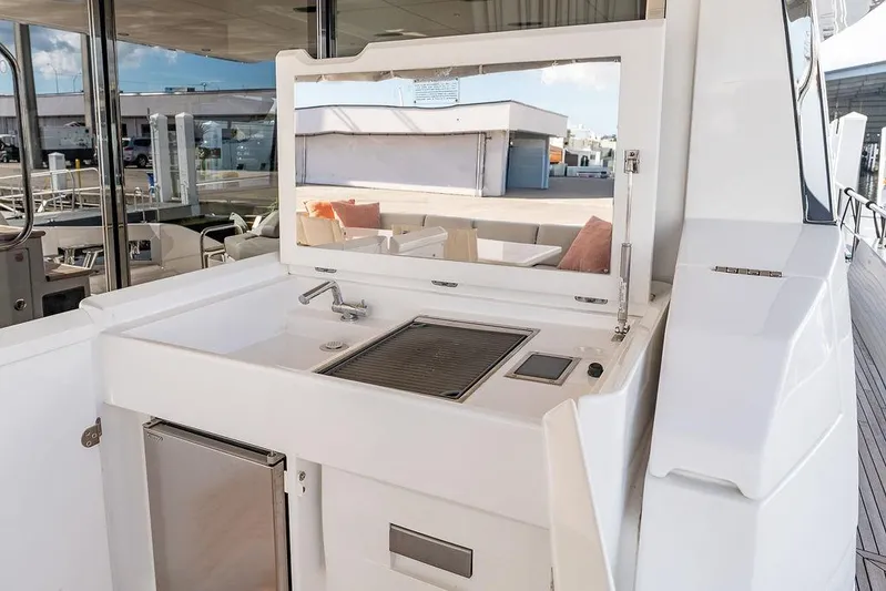  Yacht Photos Pics Outdoor kitchen area on 2022 Azimut GRANDE 25 METRI yacht, featuring grill and sink.