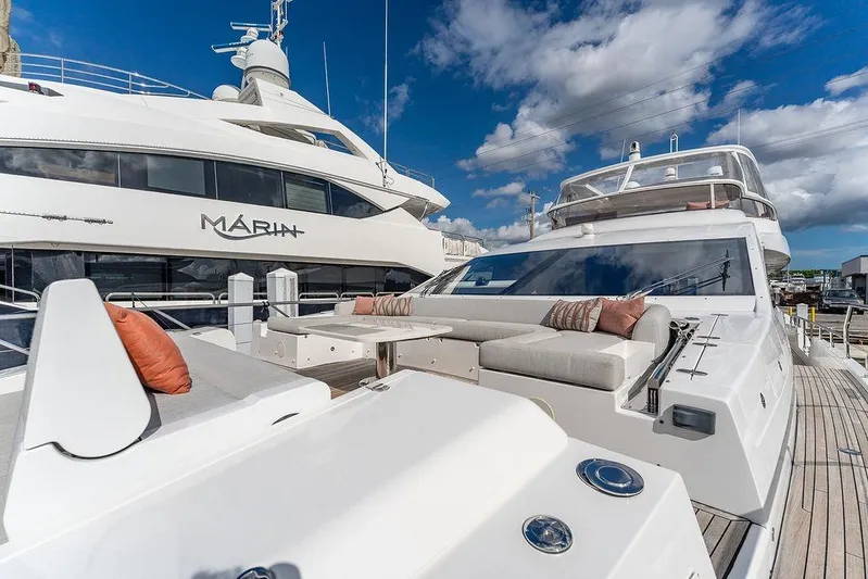  Yacht Photos Pics Luxurious 2022 Azimut GRANDE 25 METRI yacht with elegant deck seating under a clear blue sky.