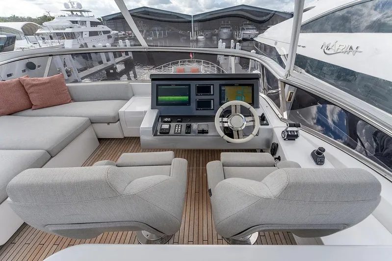  Yacht Photos Pics Luxurious helm of 2022 Azimut GRANDE 25 METRI yacht with modern controls and seating.