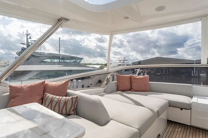  Yacht Photos Pics Luxurious 2022 Azimut GRANDE 25 METRI yacht interior with plush seating and scenic marina view.