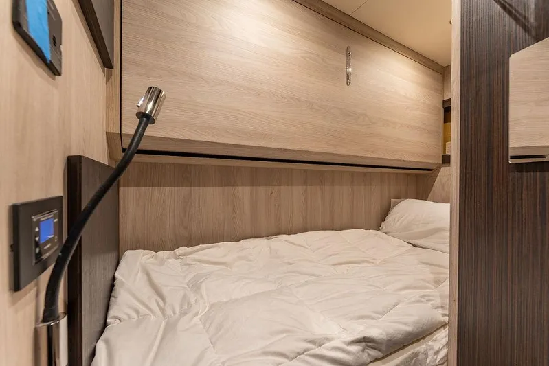  Yacht Photos Pics Cozy cabin interior of 2022 Azimut GRANDE 25 METRI yacht with modern wood paneling.