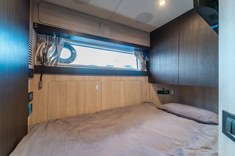  Yacht Photos Pics Luxurious cabin interior of 2022 Azimut GRANDE 25 METRI yacht with modern wood finishes.