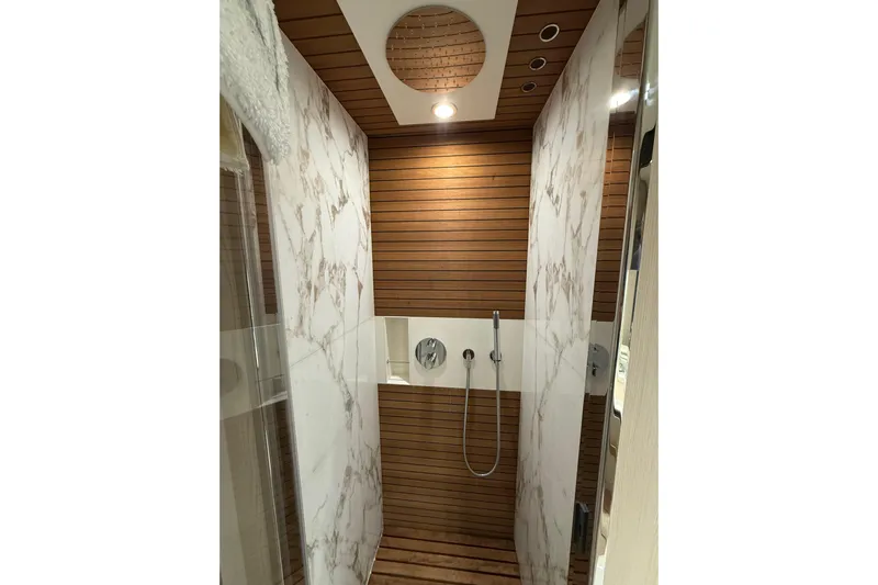  Yacht Photos Pics Luxurious shower in 2025 Azimut 25 Metri Grande yacht with wood and marble design.