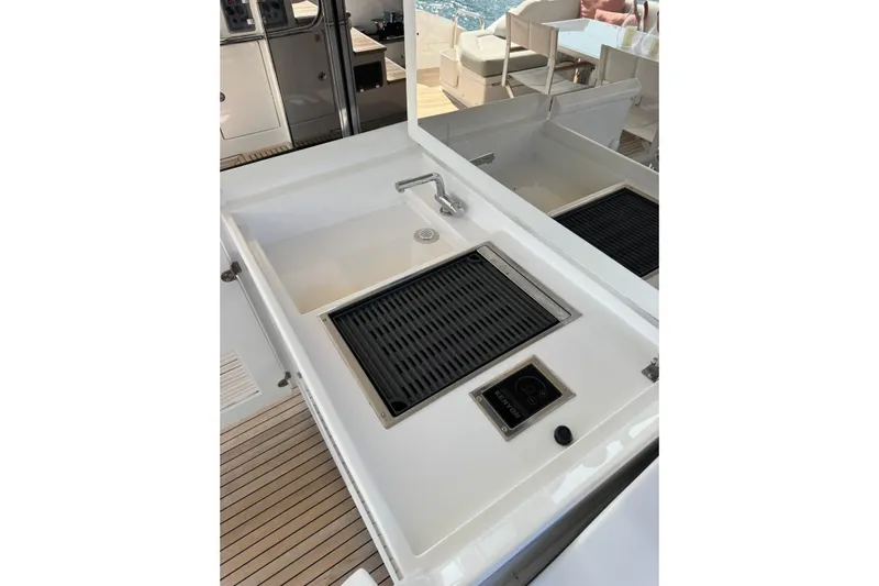  Yacht Photos Pics Outdoor kitchen area on 2025 Azimut 25 Metri Grande yacht, featuring a grill and sink.
