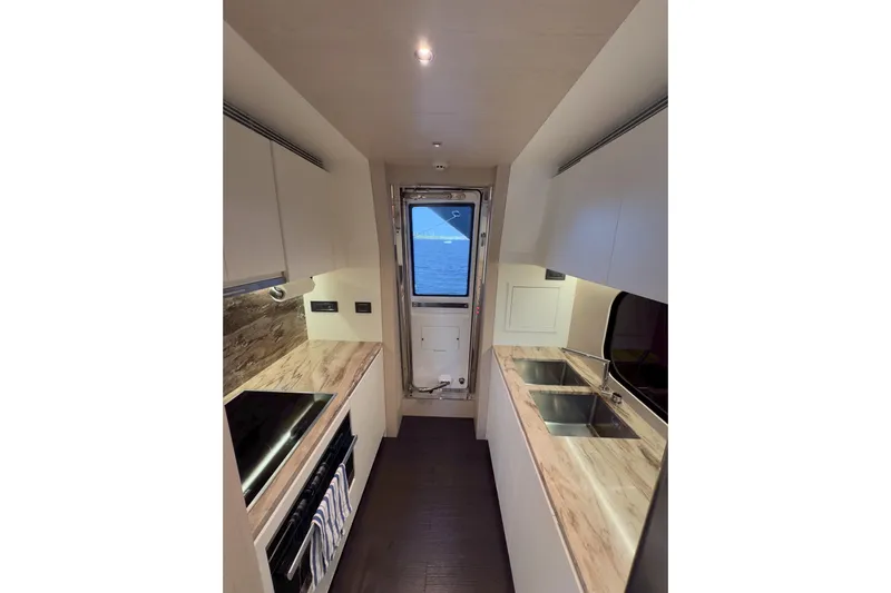  Yacht Photos Pics Modern kitchen interior of 2025 Azimut 25 Metri Grande yacht, featuring sleek countertops and dual sinks.
