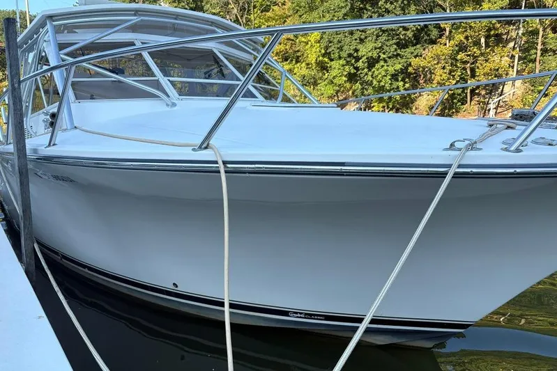  Yacht Photos Pics 2006 Carolina Classic 32 boat docked, featuring sleek white design and sturdy railings.