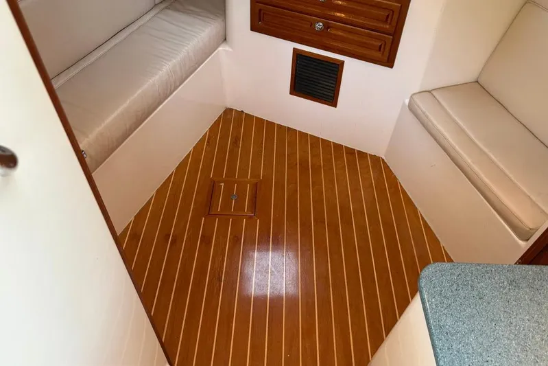  Yacht Photos Pics 2006 Carolina Classic 32 cabin interior with wood flooring and cushioned seating.