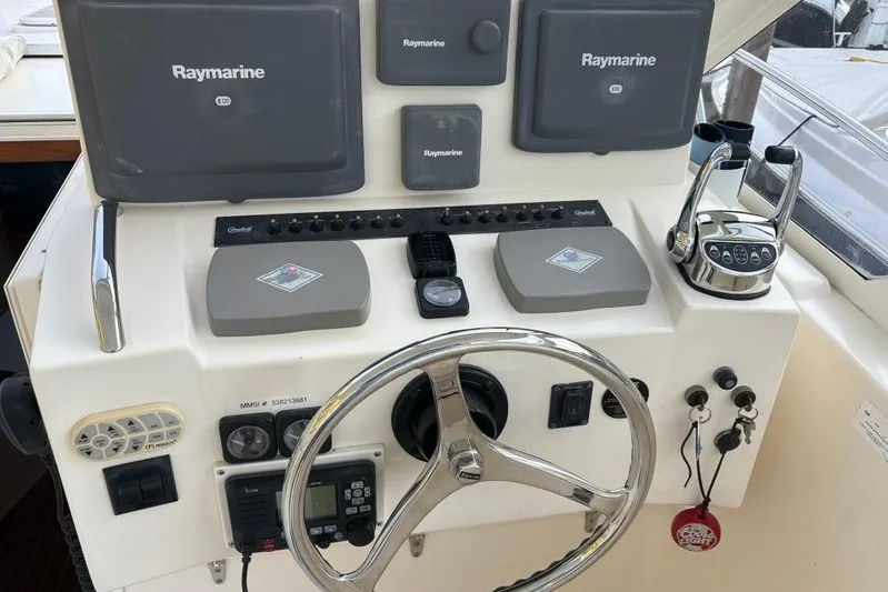  Yacht Photos Pics Helm of 2006 Carolina Classic 32 with Raymarine electronics and steering wheel.