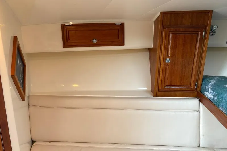  Yacht Photos Pics 2006 Carolina Classic 32 cabin interior with wooden cabinets and beige seating.