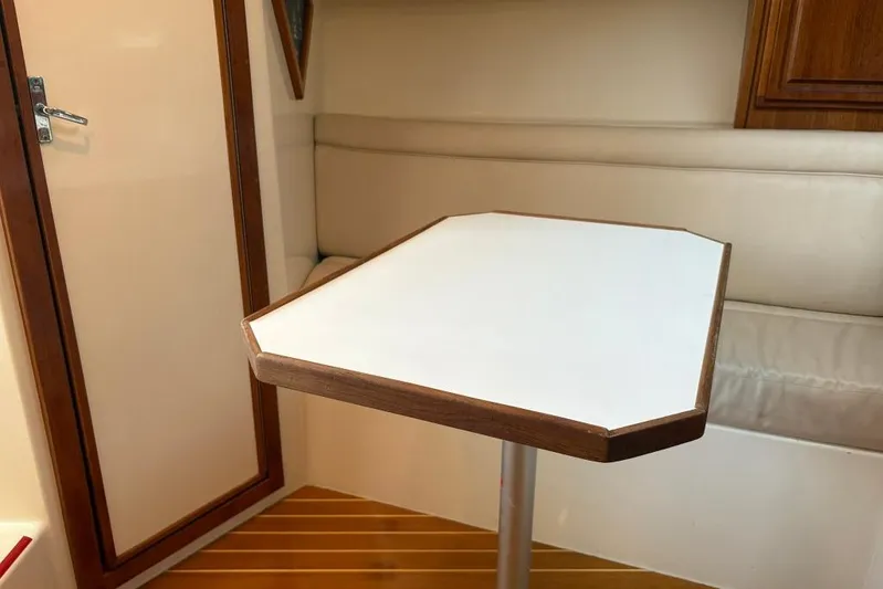  Yacht Photos Pics Interior of 2006 Carolina Classic 32 boat with table and seating area.