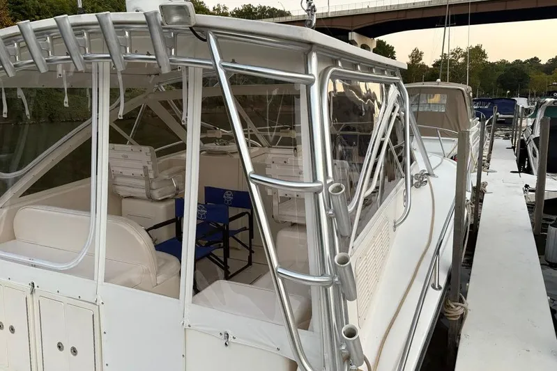  Yacht Photos Pics 2006 Carolina Classic 32 boat docked, featuring white seating and aluminum frame.