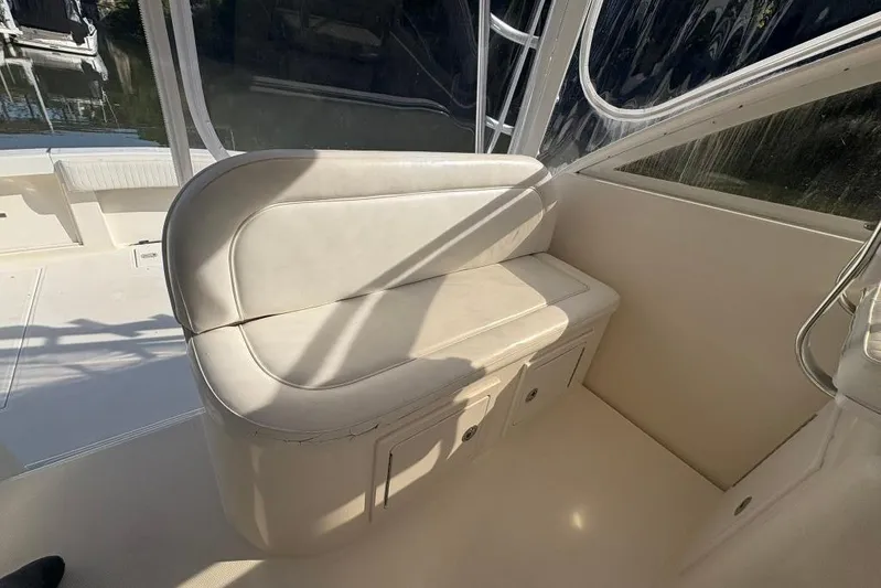  Yacht Photos Pics Interior seating of a 2006 Carolina Classic 32 boat, featuring white cushioned bench.