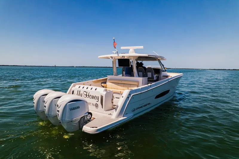 My Honey Yacht Photos Pics 2023 Regal 38 SAV boat on water with twin Yamaha engines, clear blue sky.