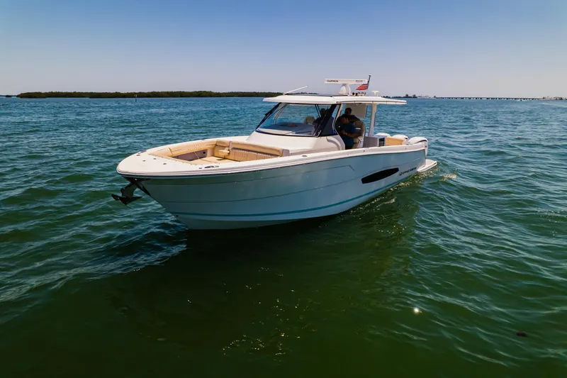My Honey Yacht Photos Pics 2023 Regal 38 SAV boat cruising on open water under clear skies.