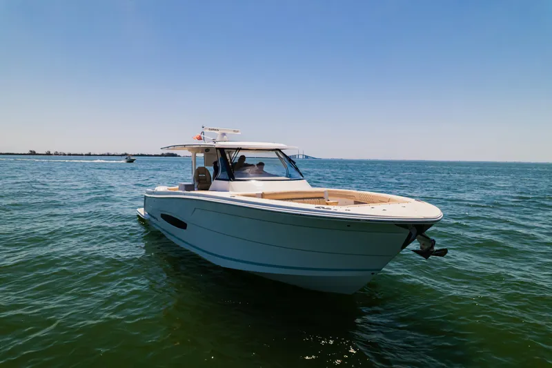 My Honey Yacht Photos Pics 2023 Regal 38 SAV boat cruising on open water under clear blue sky.