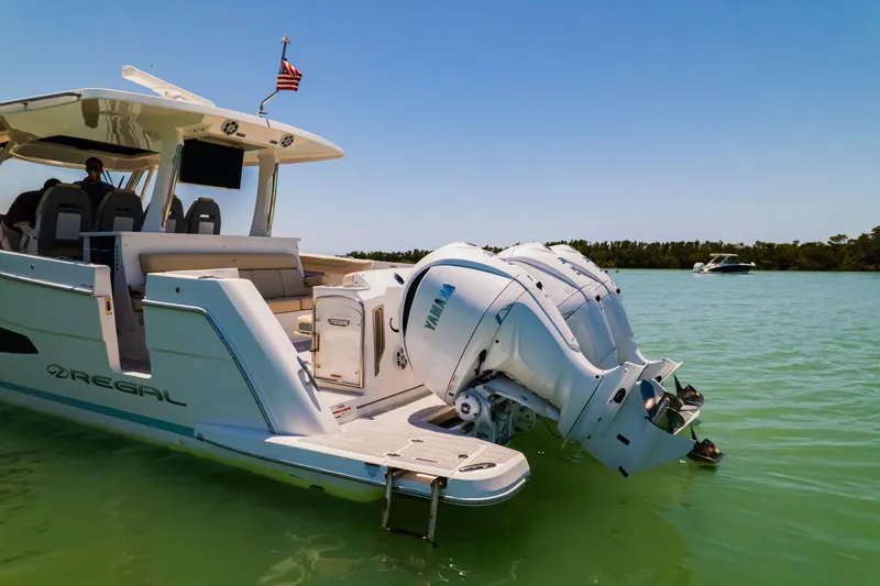 My Honey Yacht Photos Pics 2023 Regal 38 SAV boat with Yamaha engines on calm water.