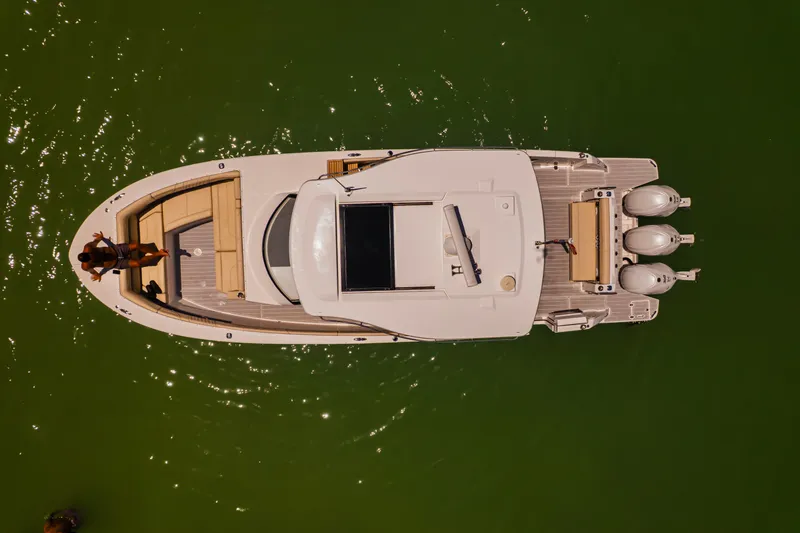 My Honey Yacht Photos Pics Overhead view of 2023 Regal 38 SAV boat on green water.