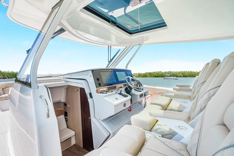 My Honey Yacht Photos Pics Luxurious interior of 2023 Regal 38 SAV yacht with modern helm and seating.